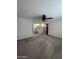 Large bedroom with neutral carpet, ceiling fan, and adjacent bathroom at 11012 W Thunderbird W Blvd, Sun City, AZ 85351