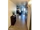 Inviting hallway featuring tile flooring, a storage cabinet, and a glimpse into the living space at 11012 W Thunderbird W Blvd, Sun City, AZ 85351