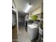Laundry room with modern washer and dryer, storage cabinets, shelving, and water heater at 11012 W Thunderbird W Blvd, Sun City, AZ 85351