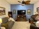 Bright living room with comfortable sofa, blue accent wall, ceiling fan, and stylish decor at 11012 W Thunderbird W Blvd, Sun City, AZ 85351