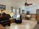 Open-concept living room with piano, reclining chair, dining table, and access to the backyard at 11012 W Thunderbird W Blvd, Sun City, AZ 85351