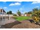 Landscaped backyard with a grassy area, patio, and citrus trees at 1210 W Missouri Ave, Phoenix, AZ 85013