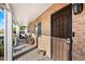 Inviting front porch with brick columns and wooden flooring at 1210 W Missouri Ave, Phoenix, AZ 85013