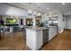 Modern kitchen with large island, stainless steel appliances, and white cabinets at 13207 E Parkview Ln, Scottsdale, AZ 85255