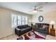 Relaxing living room with bright natural light, contemporary ceiling fan, and decorative rug at 14300 W Bell Rd # 501, Surprise, AZ 85374