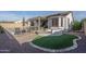 Spacious backyard showcasing pool, fire pit, covered patio, and lush landscaping perfect for relaxing at 15312 S 181St Dr, Goodyear, AZ 85338