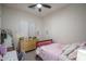 Bright bedroom with a bed, dresser, desk, and ceiling fan, providing a comfortable living space at 15312 S 181St Dr, Goodyear, AZ 85338