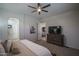 Spacious bedroom with carpet flooring, ceiling fan, dresser, and doorway to the ensuite bathroom and living area at 15312 S 181St Dr, Goodyear, AZ 85338