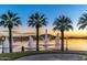 Picturesque community lake fountains at sunset, framed by palm trees at 15312 S 181St Dr, Goodyear, AZ 85338