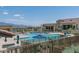 Beautiful community pool area with lounge chairs, umbrellas, and mountain views for relaxation and recreation at 15312 S 181St Dr, Goodyear, AZ 85338