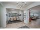 Elegant dining area features a modern chandelier, seating for six, and views of the kitchen at 15312 S 181St Dr, Goodyear, AZ 85338