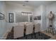 Cozy dining space with a rustic table, upholstered chairs, and a decorative area rug at 15312 S 181St Dr, Goodyear, AZ 85338