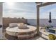 Stylish fire pit with built-in seating, lounge chairs, and desert landscaping perfect for entertaining at 15312 S 181St Dr, Goodyear, AZ 85338