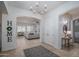 Elegant foyer showcasing a chandelier, neutral color palette, and seamless transition to living spaces at 15312 S 181St Dr, Goodyear, AZ 85338