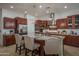 Modern kitchen with a large island, granite countertops, stainless steel appliances, and barstool seating at 15312 S 181St Dr, Goodyear, AZ 85338