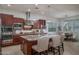 Spacious kitchen with a granite island, stainless steel appliances, pendant lighting, and seating for four at 15312 S 181St Dr, Goodyear, AZ 85338
