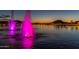 Community fountains with pink lighting at dusk, reflecting on the calm lake at 15312 S 181St Dr, Goodyear, AZ 85338