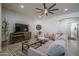 Inviting living room with a comfy sectional sofa, entertainment center, and natural lighting at 15312 S 181St Dr, Goodyear, AZ 85338