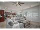 Open-concept living area with a sectional sofa, coffee table, and views into the modern kitchen at 15312 S 181St Dr, Goodyear, AZ 85338
