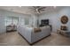 Stylish living room with a gray sectional, decorative throw, and direct views of the backyard at 15312 S 181St Dr, Goodyear, AZ 85338