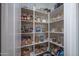 Well-organized pantry with shelving, baskets, and various food items in glass jars and containers at 15312 S 181St Dr, Goodyear, AZ 85338