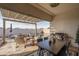 Inviting covered patio with dining, seating, and barbecue area overlooking the refreshing pool at 15312 S 181St Dr, Goodyear, AZ 85338