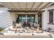 Cozy outdoor patio area with comfortable seating, dining table, grill and decorative pergola with string lights at 15312 S 181St Dr, Goodyear, AZ 85338