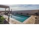 Private pool and lounging area, framed by a pergola, offering a serene space for relaxation at 15312 S 181St Dr, Goodyear, AZ 85338