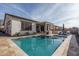 Inviting backyard featuring a sparkling pool, covered patio, and comfortable lounge seating for relaxing at 15312 S 181St Dr, Goodyear, AZ 85338