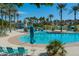 Resort-style community pool with lounge chairs, turquoise umbrellas, and lush landscaping at 15312 S 181St Dr, Goodyear, AZ 85338