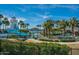 Resort-style pool with waterslide, palm trees, and mountain views in a Gathering friendly community at 15312 S 181St Dr, Goodyear, AZ 85338