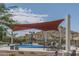 Fun splash pad area for with shade cover, tables and chairs, and mountain views in background at 15312 S 181St Dr, Goodyear, AZ 85338