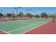 Well-maintained tennis courts with covered seating areas in a lush community setting at 15312 S 181St Dr, Goodyear, AZ 85338