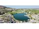 Panoramic aerial view of a lush golf course with a serene lake nestled between rocky terrain and scenic mountain backdrops at 2135 N Heritage St, Buckeye, AZ 85396