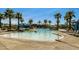 Inviting community pool offers a refreshing escape with clear waters, palm trees, and plenty of space to lounge at 2135 N Heritage St, Buckeye, AZ 85396