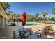 Refreshing community pool featuring sun umbrellas, lounge chairs, and a vibrant atmosphere perfect for relaxation and fun at 2135 N Heritage St, Buckeye, AZ 85396