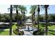 Stunning community view down tree lined street with palm trees and green landscape in a serene and inviting environment at 2135 N Heritage St, Buckeye, AZ 85396