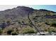 Scenic shot of a hiking trail on a mountain, featuring stairs and rocky terrain with lush green foliage at 2135 N Heritage St, Buckeye, AZ 85396