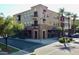 Corner view of three-story, mixed use commercial and residential building with brick accents and outdoor dining at 2135 N Heritage St, Buckeye, AZ 85396