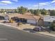 Single-story home with tile roof and a two car garage next to golf course at 4047 E Catalina Cir, Mesa, AZ 85206