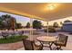 Backyard patio with seating area and view of a golf course at sunset at 4047 E Catalina Cir, Mesa, AZ 85206