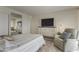 Bedroom with striped bedding and a comfortable recliner at 4047 E Catalina Cir, Mesa, AZ 85206