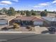 Single story home with tile roof, two-car garage, and landscaped yard at 4047 E Catalina Cir, Mesa, AZ 85206