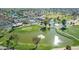 Aerial view of a community with a swimming pool, lake, golf course and community center at 10214 E Michigan Ave, Sun Lakes, AZ 85248
