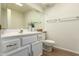Bright white bathroom with white cabinets, sink, and toilet at 10214 E Michigan Ave, Sun Lakes, AZ 85248