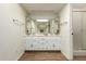 Bright bathroom featuring a double sink vanity with a mirror and wood flooring at 10214 E Michigan Ave, Sun Lakes, AZ 85248