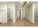 Hallway with wood floors and closet with mirrored doors at 10214 E Michigan Ave, Sun Lakes, AZ 85248