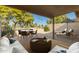 Relaxing patio with seating area, umbrella, and golf course view at 10214 E Michigan Ave, Sun Lakes, AZ 85248