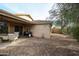 Gravel backyard with patio and partial view of house at 17475 W Caribbean Ln, Surprise, AZ 85388
