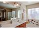 Double vanity bathroom with shower and bathtub at 17475 W Caribbean Ln, Surprise, AZ 85388